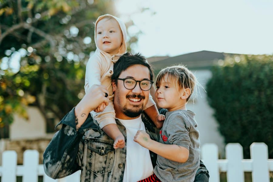 A dad carrying his two young children