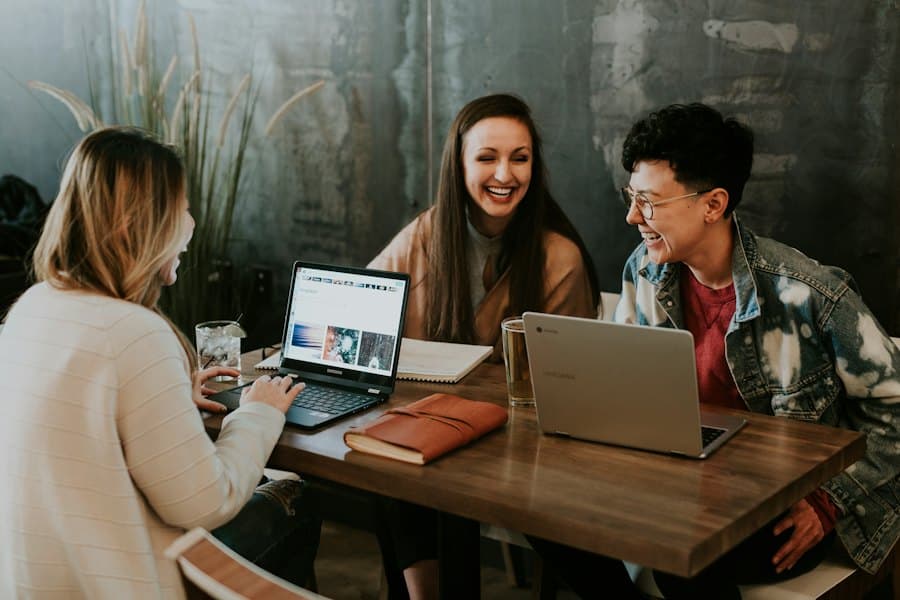 Friends planning together at a table with laptops
